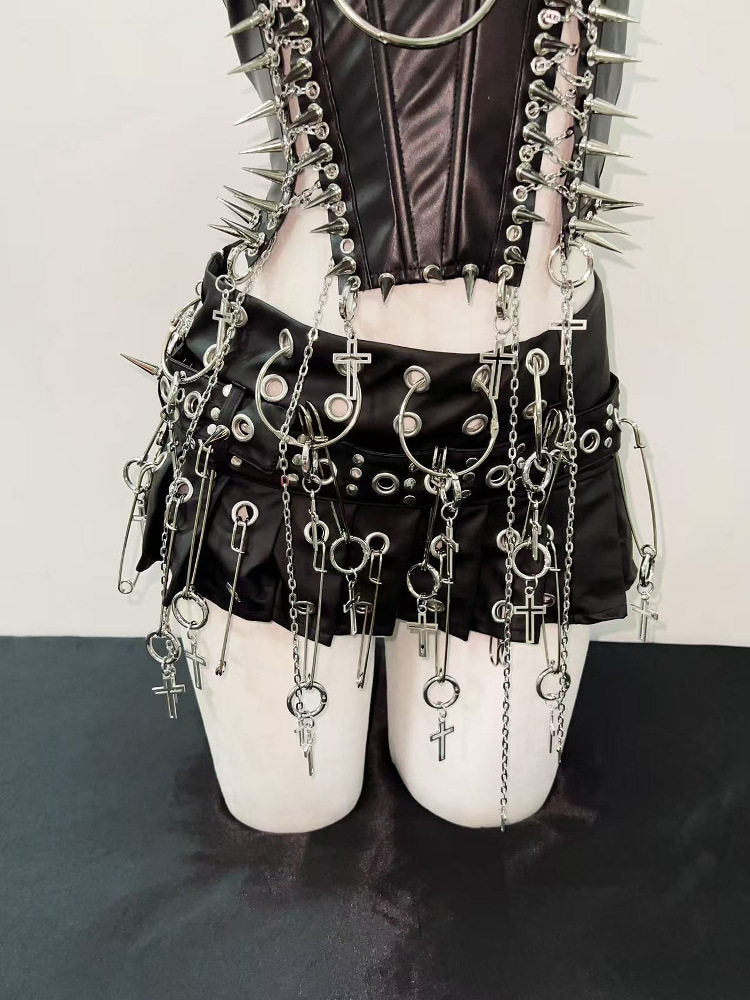Lower view of studded punk skirt with hanging chains and cross charms over the hips