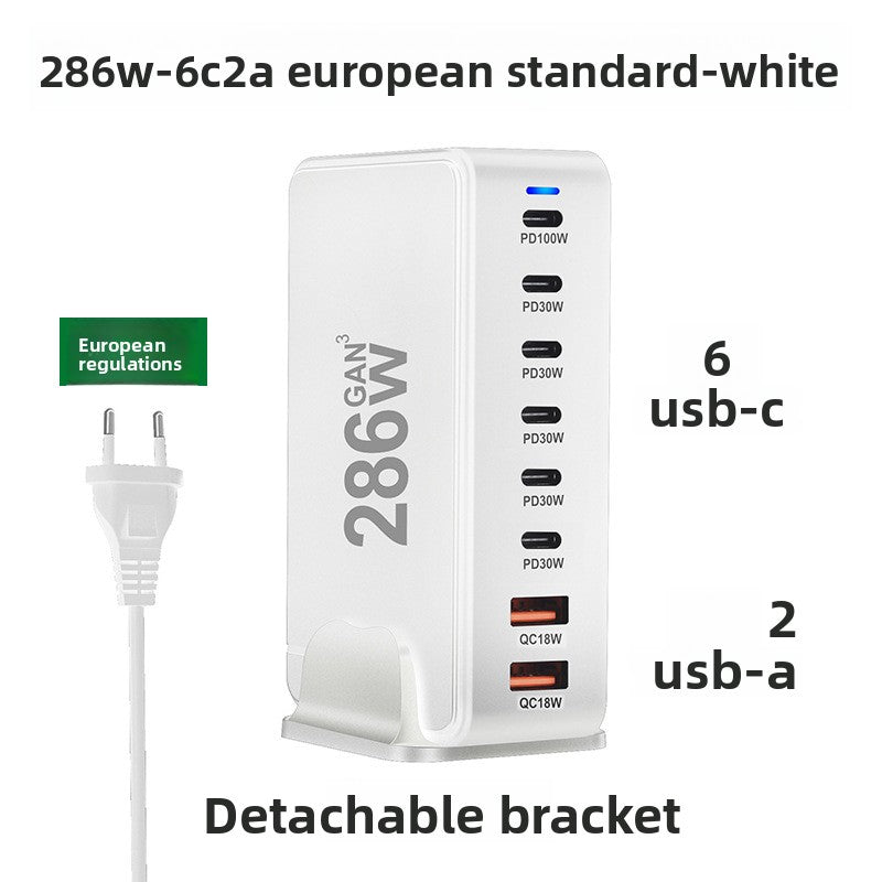 GaN charging tower shown next to a phone and cable to indicate its compact desktop size