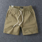 Khaki men's cotton drawstring shorts showing the elastic drawstring waistband