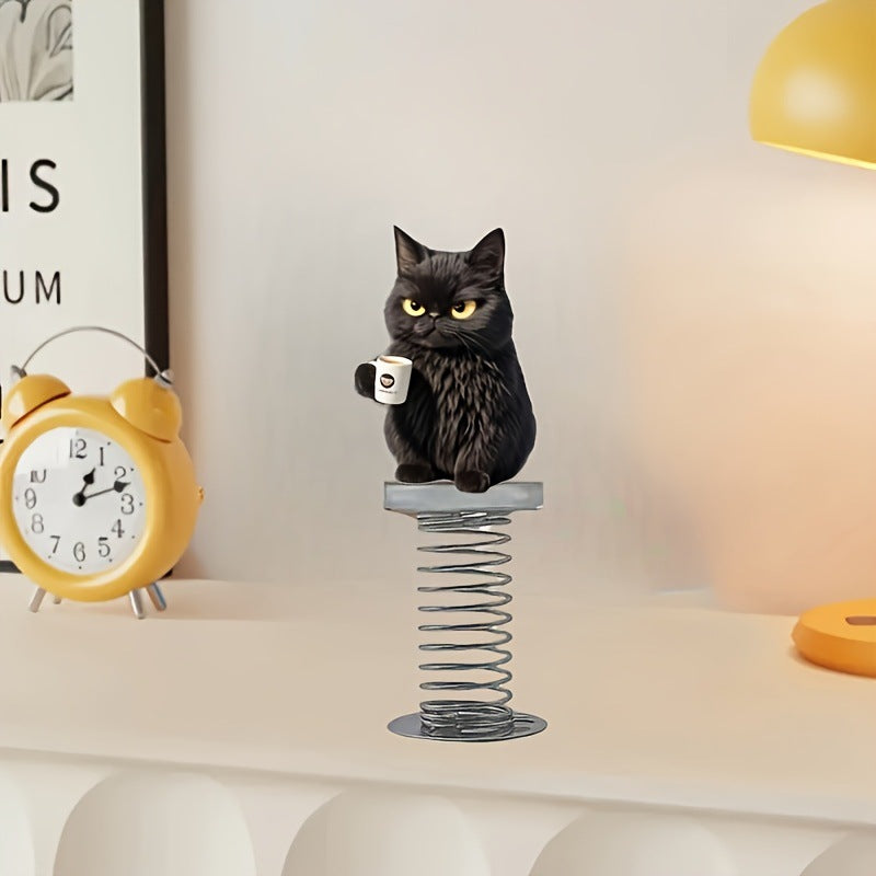 Black cat spring ornament on a desk shelf beside a yellow alarm clock and a warm lamp