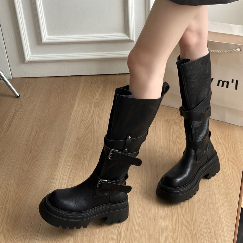 Platform buckle boots on a chunky lugged rubber sole seen from the side
