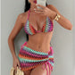 Three piece bikini set laid flat on a marble surface