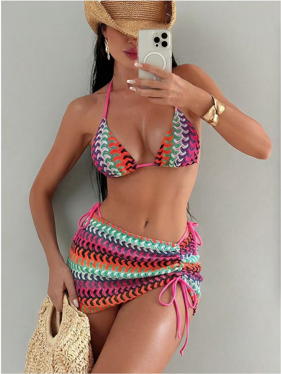 Three piece bikini set laid flat on a marble surface
