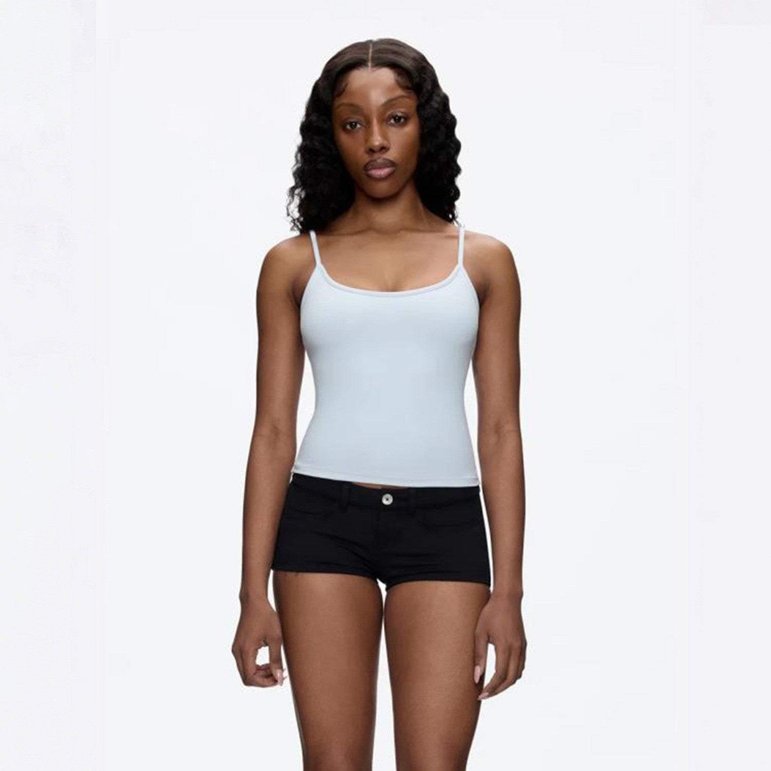 Two thin adjustable spaghetti straps on a fitted scoop neck camisole