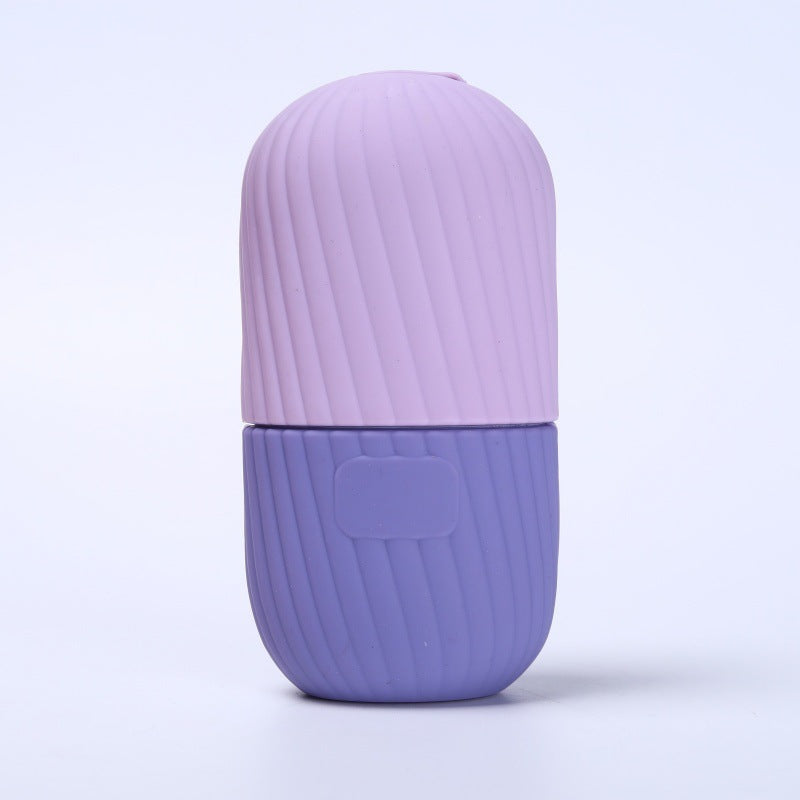 Yellow silicone facial ice tool showing the separable cap that sits over the base