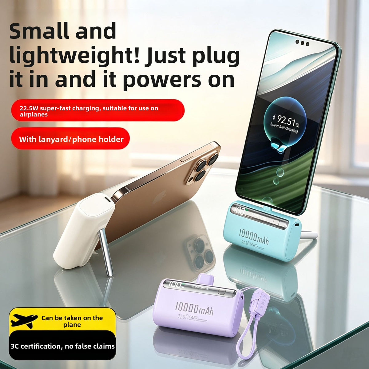 Capsule power banks charging phones on a glass table, one phone resting upright on a fold-out stand