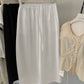 White cotton barrel leg trousers hung with elastic drawstring waist detail