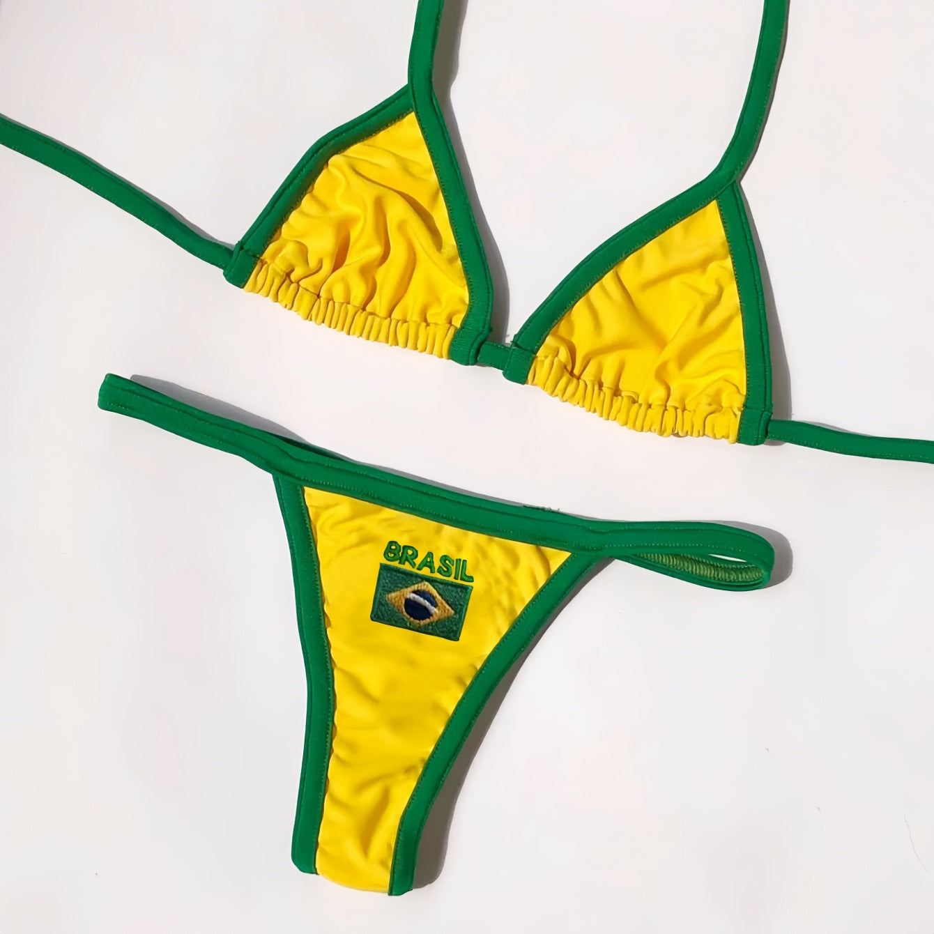 Yellow Brasil bikini set on dark wood with green binding detail
