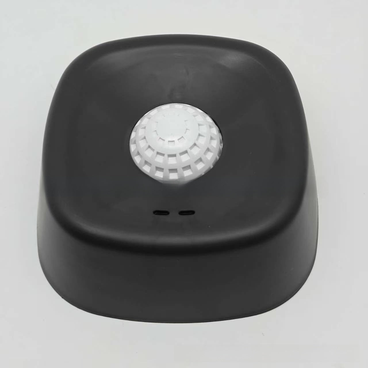 Dog slow feeder lick bowl shown from the front with its ridged tray and center ball