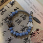 Ceramic beads strand in soft studio light showing earth-tone glaze colors
