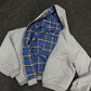 Black reversible zip hooded sweatshirt, solid black outer with a yellow tartan plaid reverse