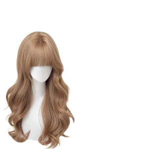 Long wavy champagne gold wig with straight wispy bangs on a plain white mannequin head