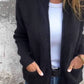 Black zip-front knit cardigan with two patch pockets, size M