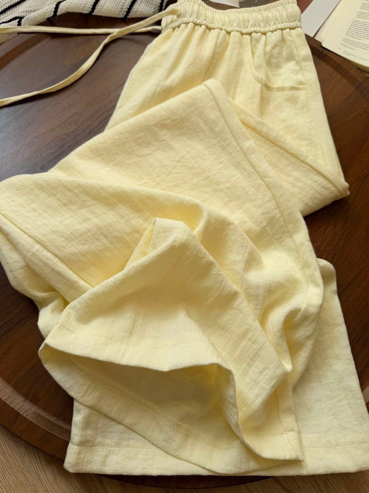 Close view of pale yellow linen blend fabric showing the slubbed weave