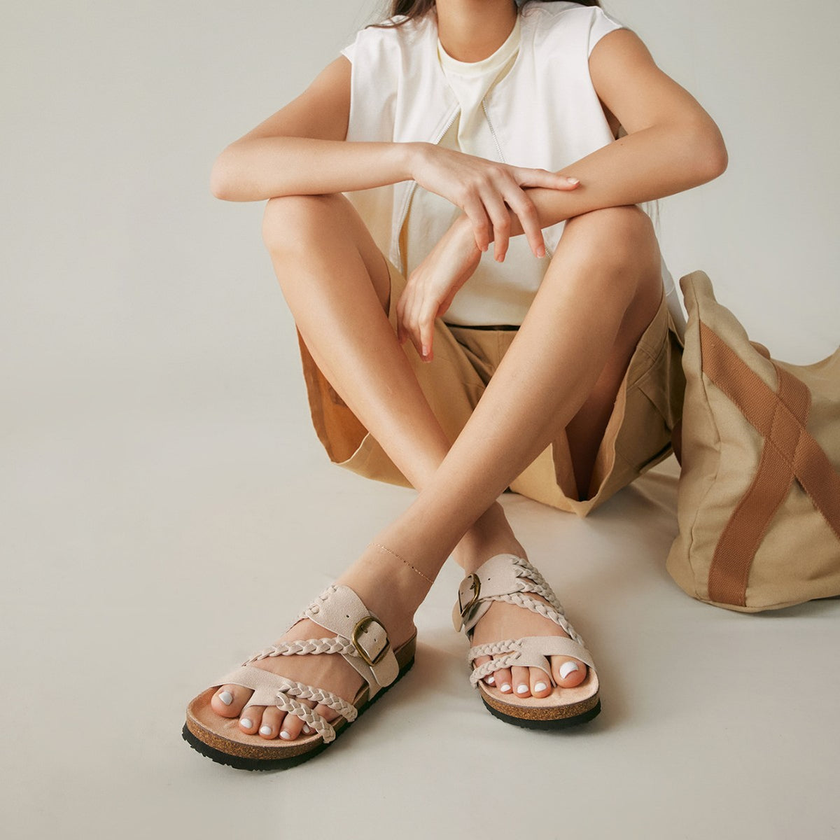 Side profile of the woven sandal showing the adjustable buckle strap and flat sole