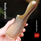 Close up of the glossy marbled amber and cream handle of the plastic hair comb