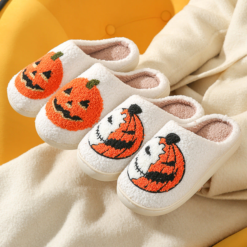 Cream plush slippers with tufted orange jack o lantern pumpkin designs on a cream coat