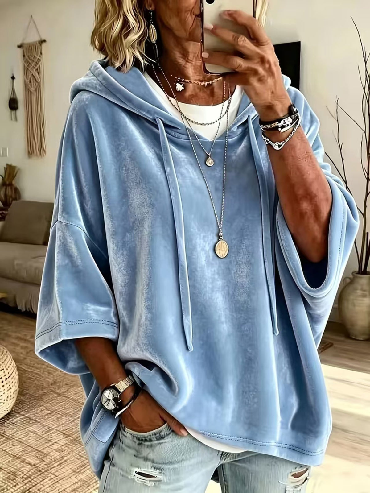 Drawstring hood and roomy body of a loose womens hooded pullover top