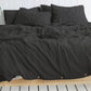 Solid color cotton linen duvet cover with coconut buttons and matching pillowcases on a bed