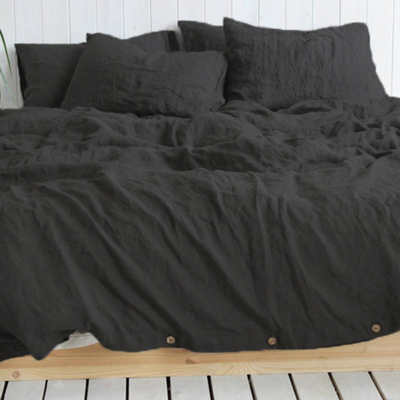 Solid color cotton linen duvet cover with coconut buttons and matching pillowcases on a bed
