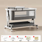 Gray baby crib with a white frame and a nursing table on top, Nursing model shown, light gray option