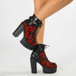 Womens platform ankle boot shown on foot with a chunky block heel and lug platform