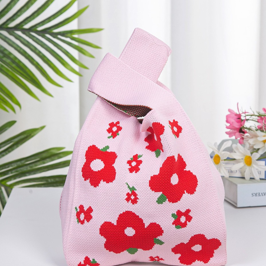 Knitted pattern wrist bag with a soft unstructured body and open top