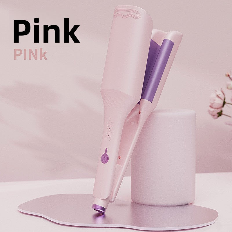 Pink deep wave hair iron on a pink podium under the maker label for the Pink colour