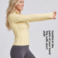 Woman in a yellow stand collar zip jacket reaching one arm forward, side view showing the thumb holes
