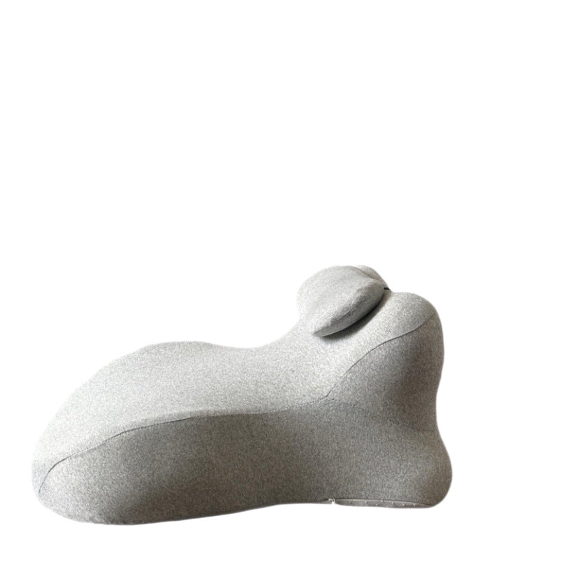 Light gray back cushion in profile on white, small neck roll strapped into the upper valley
