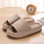 Hand holding the slipper to show flexibility of the sole