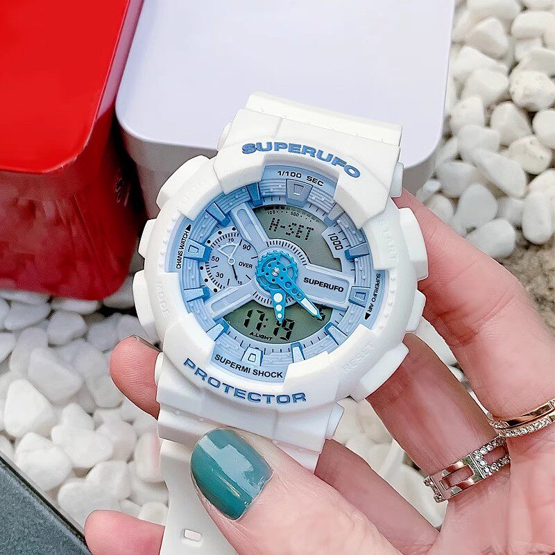Watch face glowing blue against a darker bedroom background