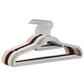 Stack of flocked hangers in gray, pink, black and off-white with silver hooks on white
