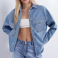 Woman wearing a washed blue denim shirt jacket with chest pocket, Blue size L variant image