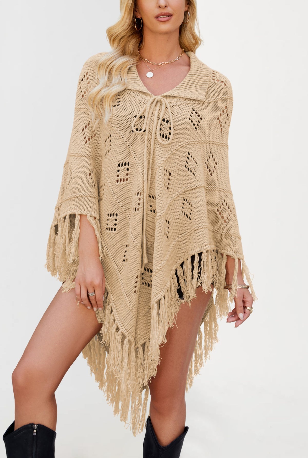 Womens knit fringe poncho falling open over the arms in a cape shape with pointed hem