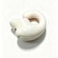 Pale pink option, Boxed: cream colored clip-on earphone with a round button on a white background
