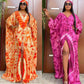 Tie dye batwing kaftan maxi dress with a V neckline and floor length hem on a standing model