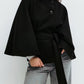 Belted cape jacket shown from the front with its self tie belt and stand collar buttons