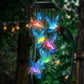 Blue hummingbird LED figures hanging from a solar lamp head, glowing at night, black housing option