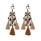 Handmade bohemian clip-on earrings with tassel and bead drop detail, zinc alloy frame, studio shot on white background