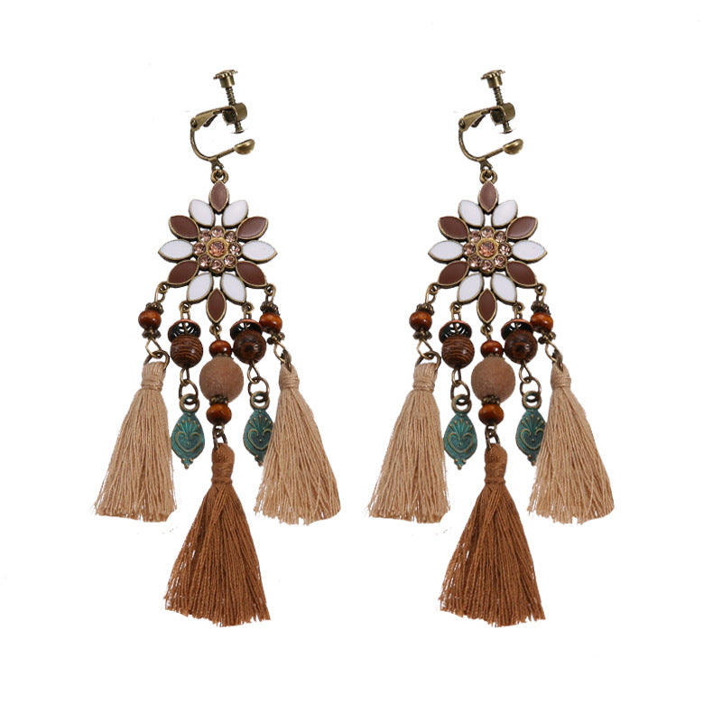 Handmade bohemian clip-on earrings with tassel and bead drop detail, zinc alloy frame, studio shot on white background