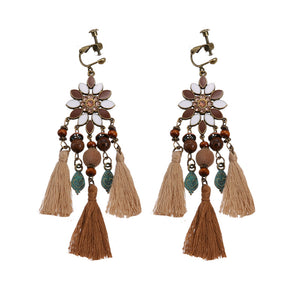 Handmade bohemian clip-on earrings with tassel and bead drop detail, zinc alloy frame, studio shot on white background