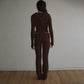 Ribbed knit two piece set worn seated to show the close fit in a solid color
