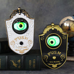 Halloween eyeball doorbell props, black and white ornate PVC plaques each with a green glowing eye and Push To Ring