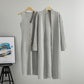 Grey ribbed knit dress and matching long cardigan displayed together on wooden hangers