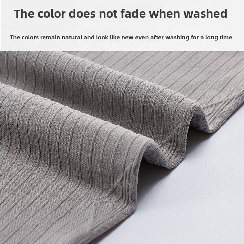 Close up of grey ribbed nylon maternity legging fabric folded on a light surface