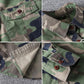 Men's washed camouflage long sleeve button shirt with two flap chest pockets close up on the two flap chest pockets
