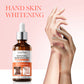 Sadoer body essence bottle held near a hand on a soft pink studio background