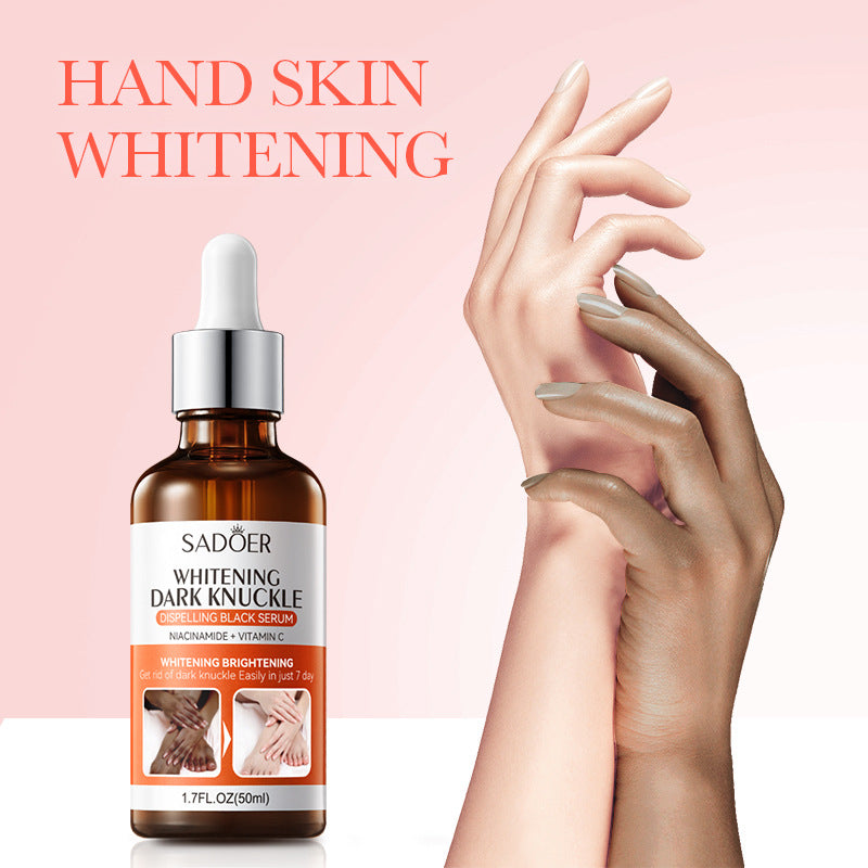 Sadoer body essence bottle held near a hand on a soft pink studio background