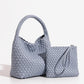 Grey woven PU bucket bag from the side with its matching zip pouch and wrist loop set beside it